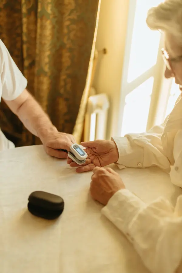 A pulse oximeter clipped to an elderly patient’s finger
